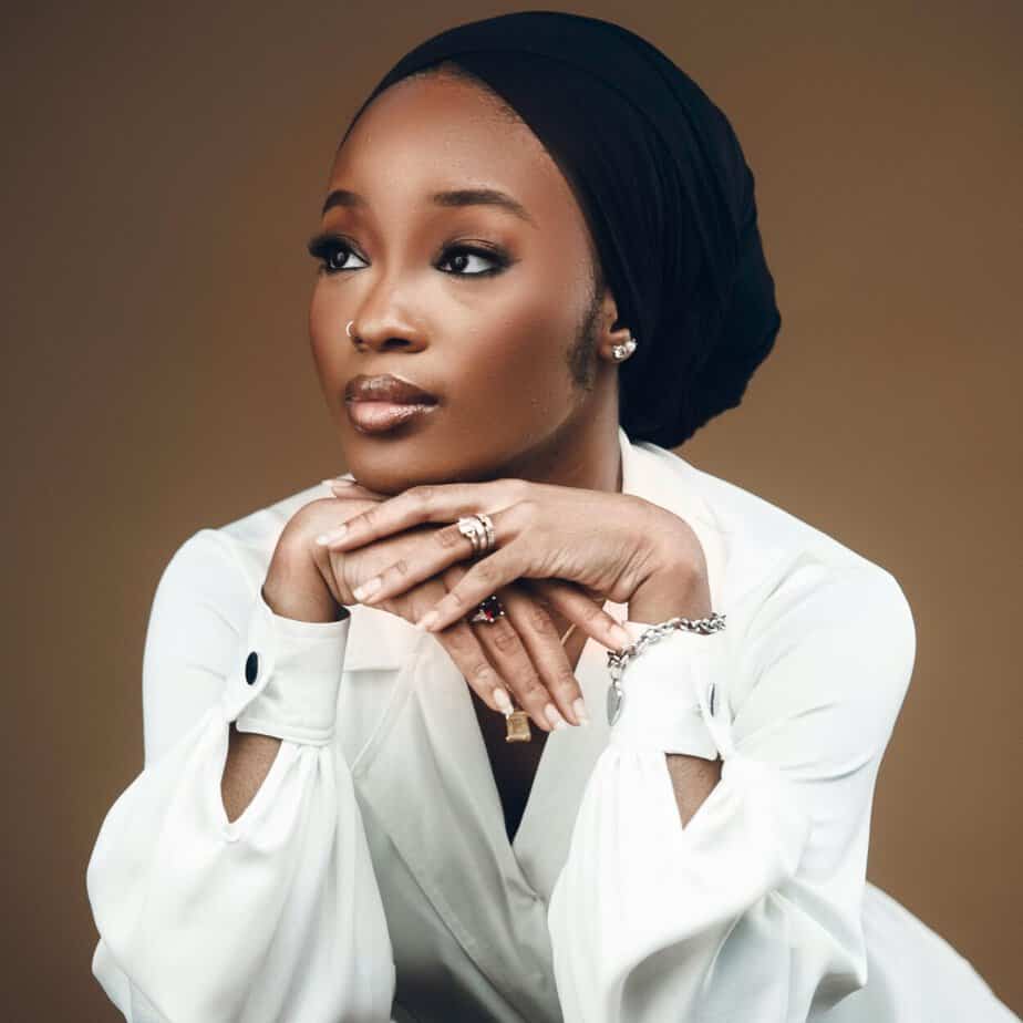 Women sitting down with white shirt thinking about Black Owned Beauty Brands
